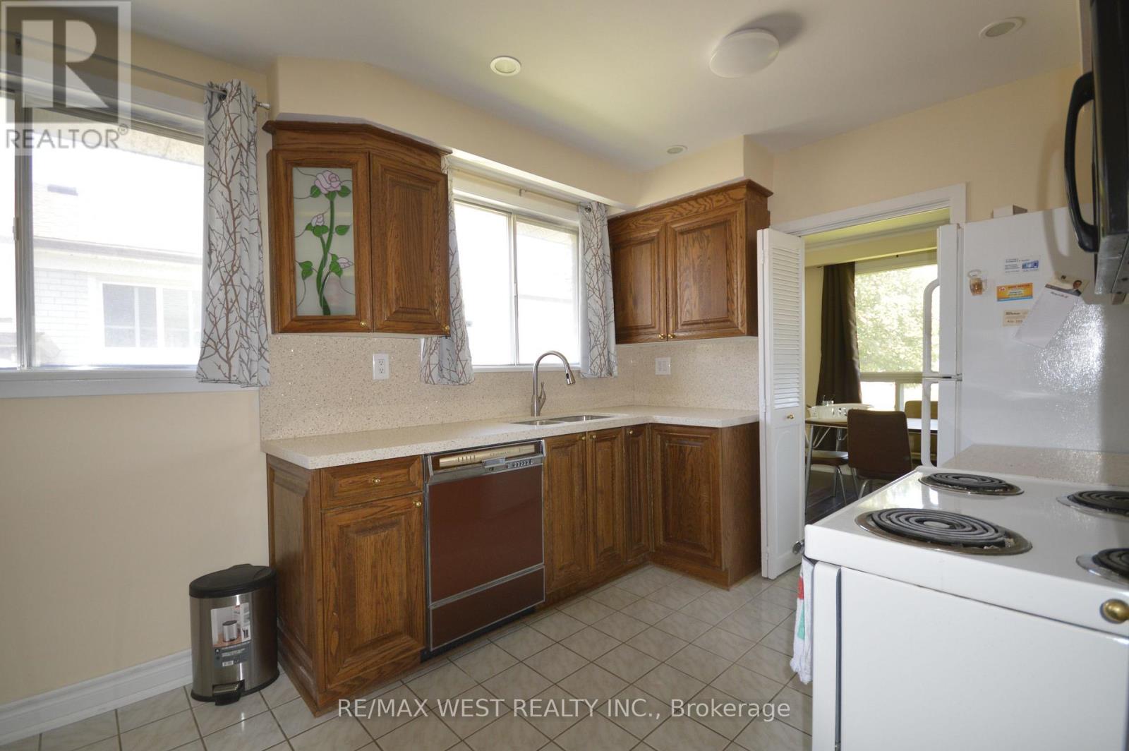 A kitchen with wooden cabinets and a white refrigerator.