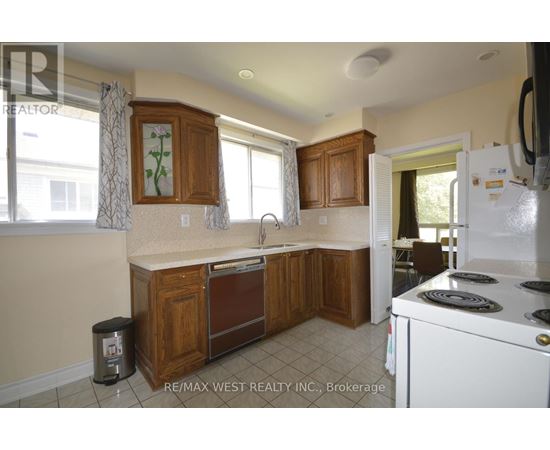 A kitchen with wooden cabinets and a white refrigerator.