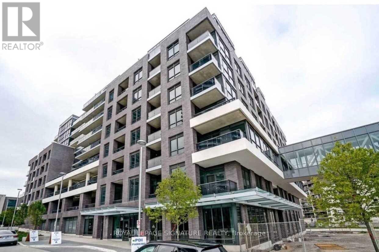 A modern multi-story building with a glass facade and balconies.