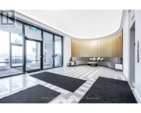 A modern office lobby with a curved wall and a bench.