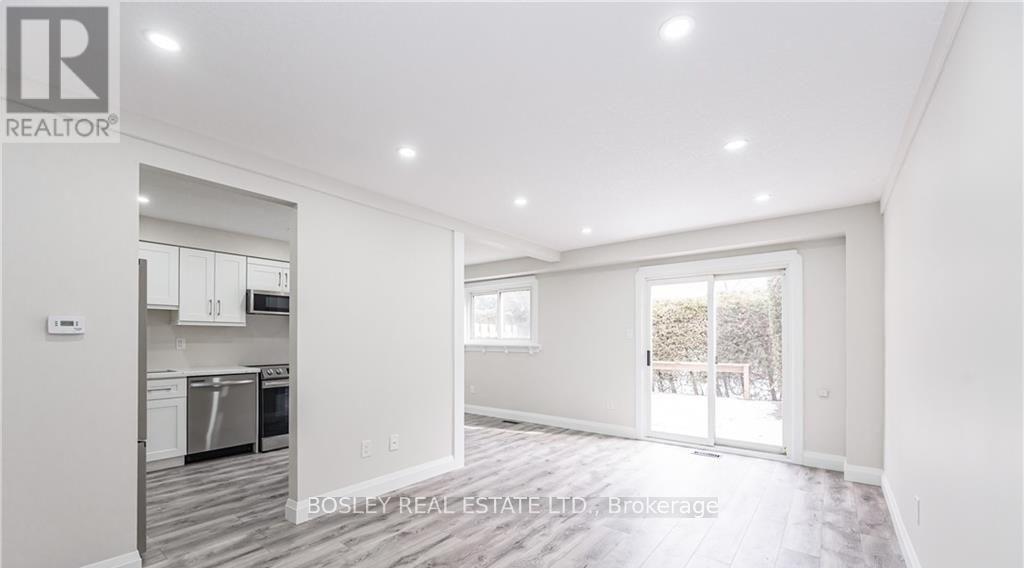 A spacious, well-lit room with a kitchen area and a dining table.