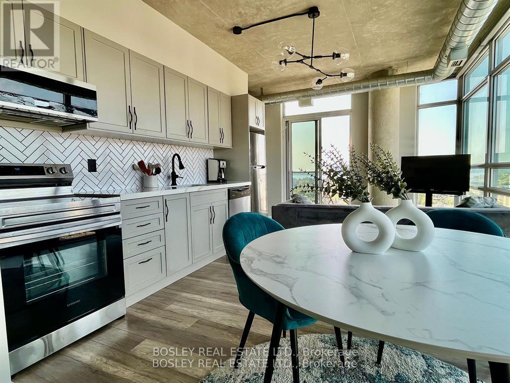 A modern kitchen with a marble table and a view of the outdoors.