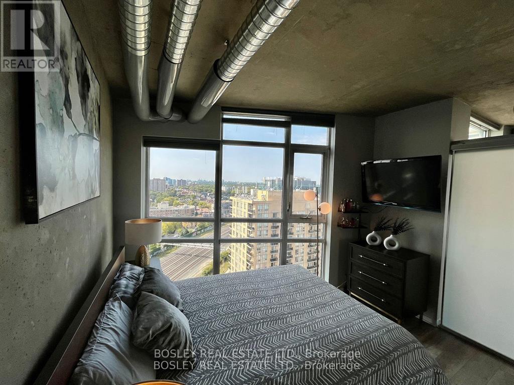 A bedroom with a large bed and a view of the city.