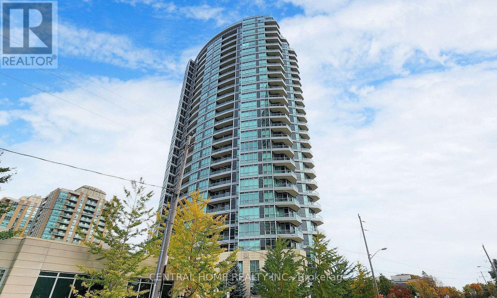 A tall residential building with many windows and balconies.