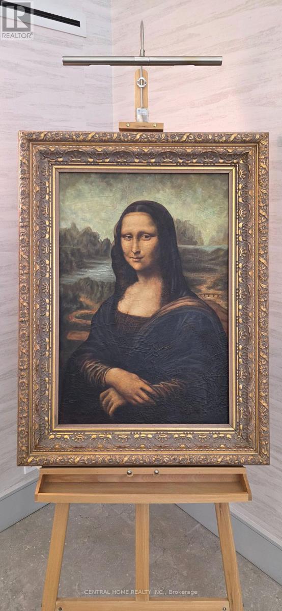 A painting of a woman in a blue dress is displayed on an easel.