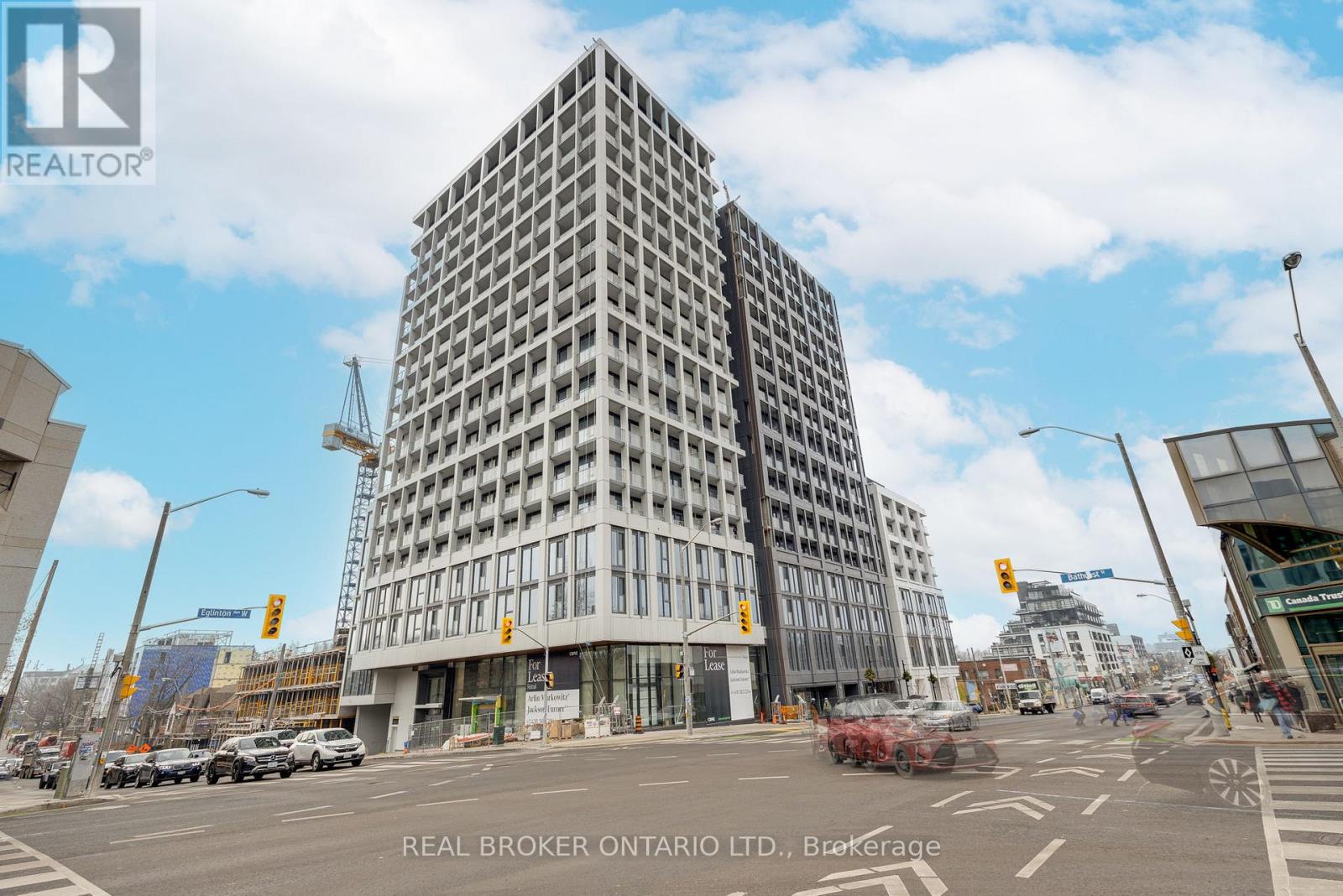 A tall building with a glass facade is the focal point of the image.
