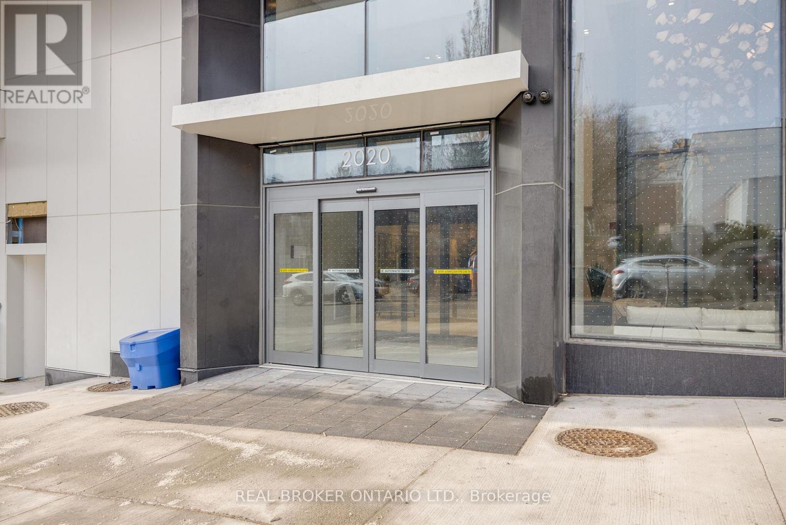 The image shows the front of a building with the sign "REALTOR®" on it.