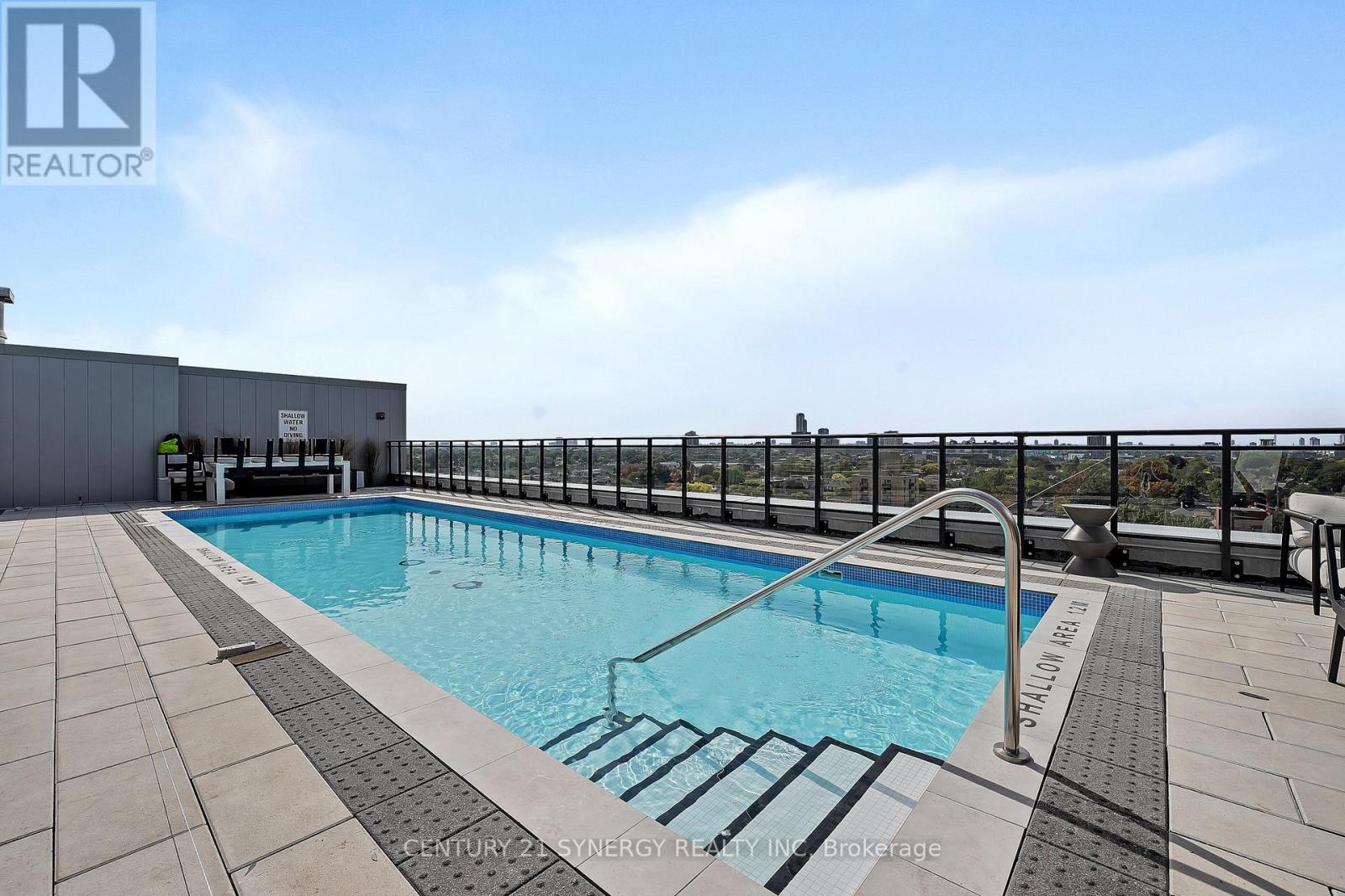 A pool with a metal railing around it.
