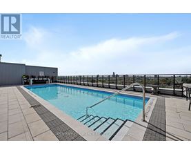 A pool with a metal railing around it.