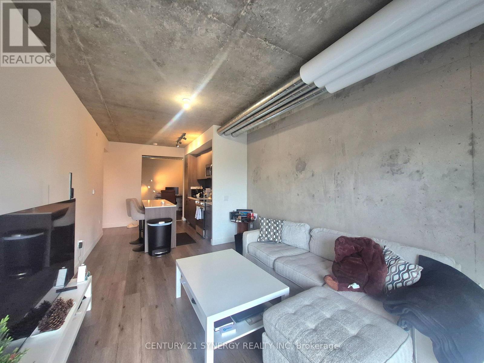 A living room with a grey couch and a white coffee table.