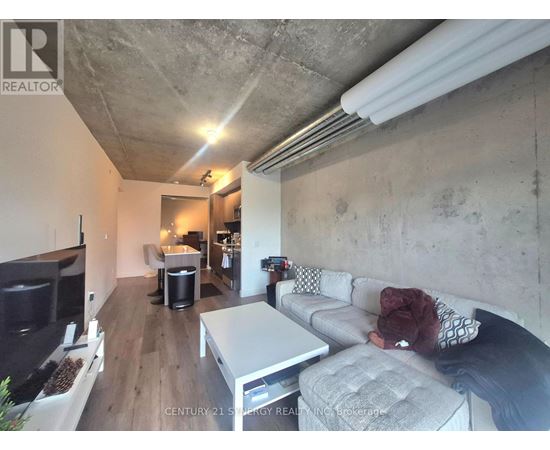 A living room with a grey couch and a white coffee table.