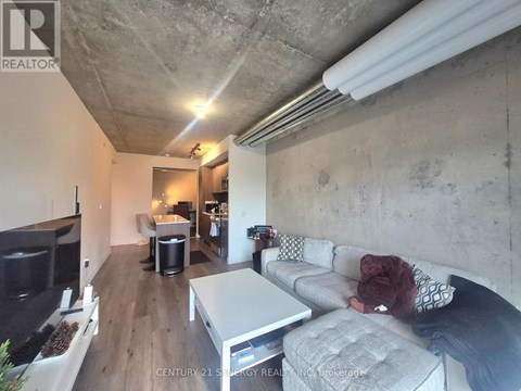 A living room with a grey couch and a white coffee table.