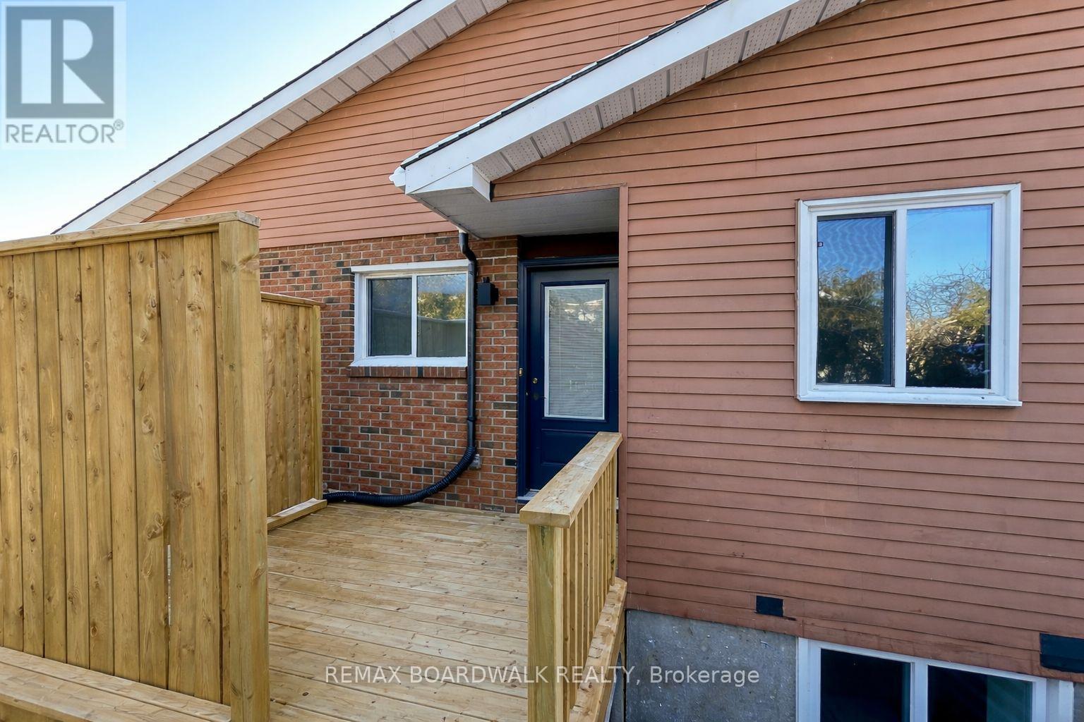 A house with a brown siding and a wooden fence.