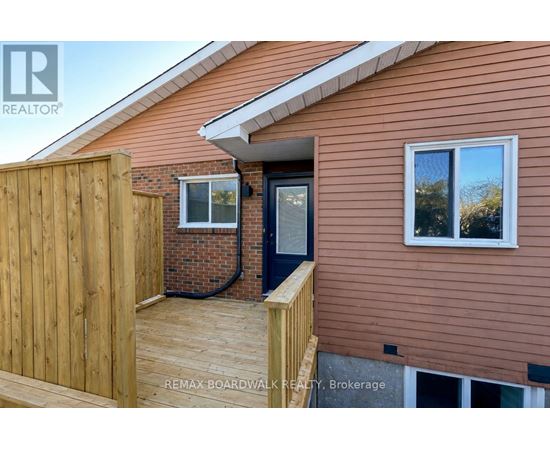 A house with a brown siding and a wooden fence.