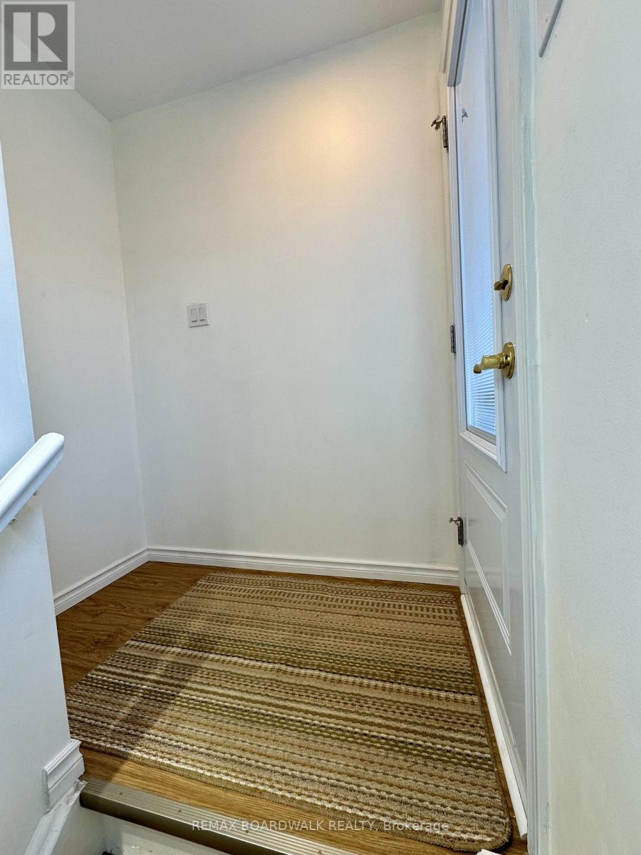 A hallway with a carpeted floor and a white door.