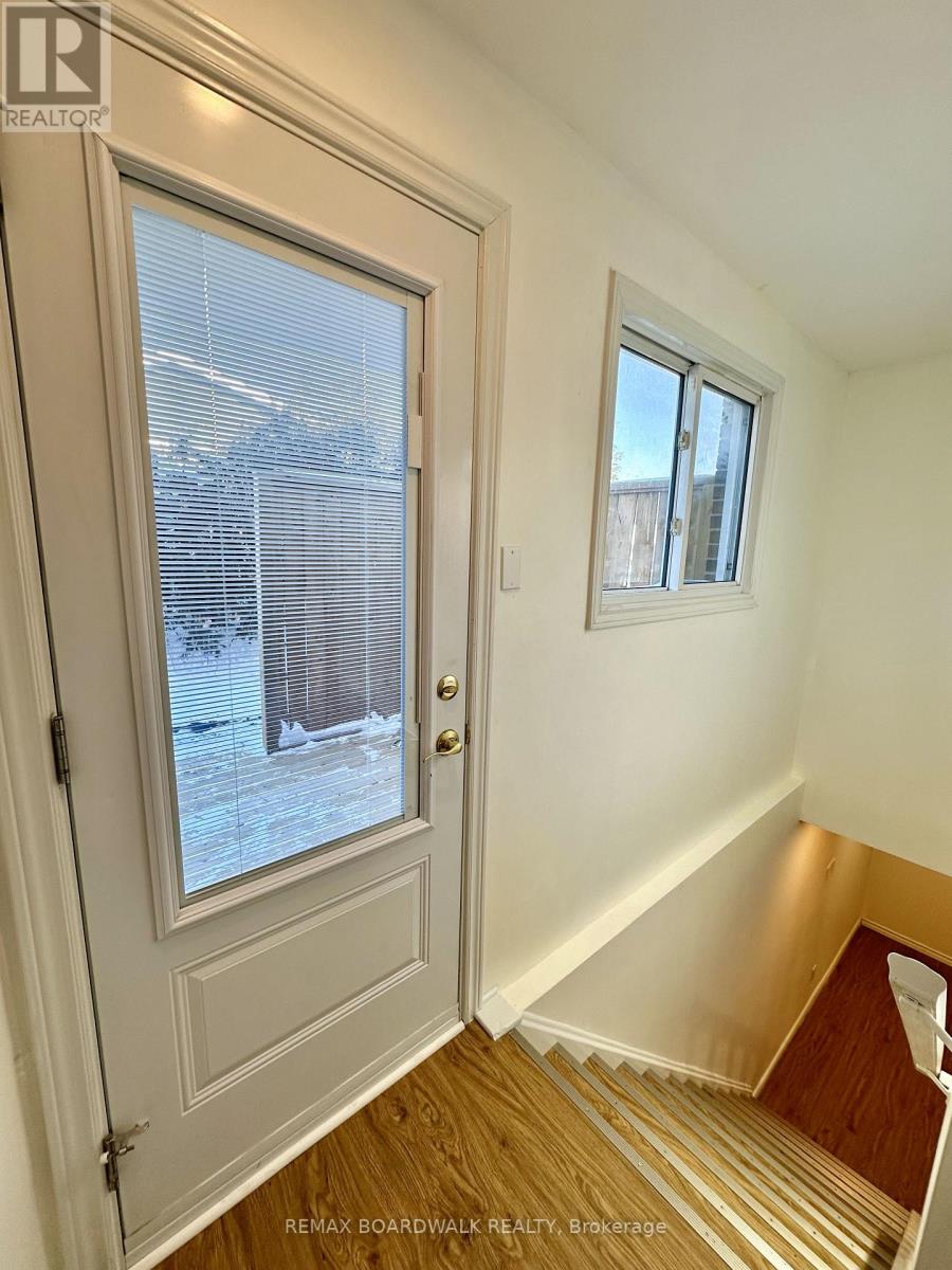 A white door with a window and a small window above it.