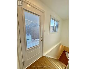 A white door with a window and a small window above it.