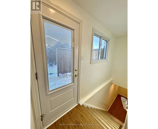 A white door with a window and a small window above it.
