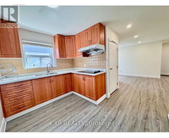 A kitchen with wooden cabinets and a white countertop.