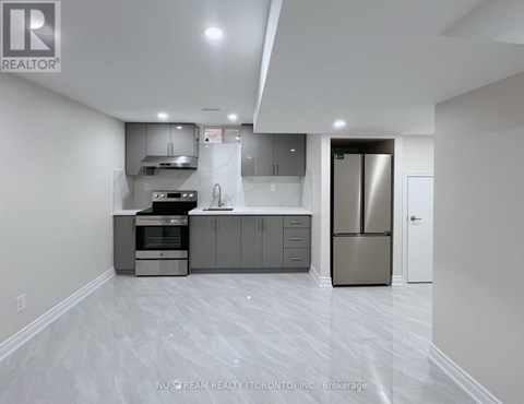 A modern kitchen with stainless steel appliances and white cabinetry.