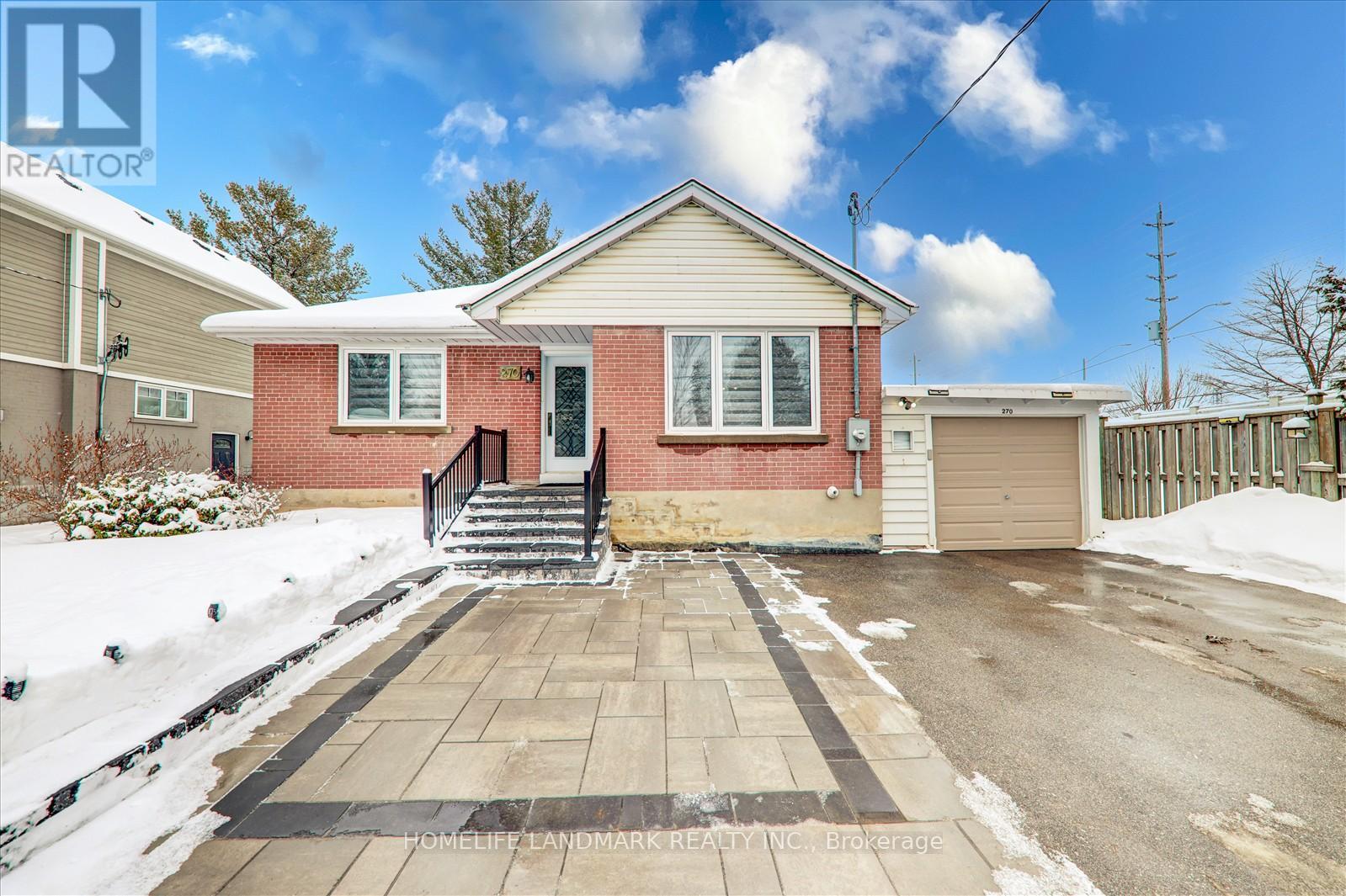 A house with a snow-covered roof and a driveway.