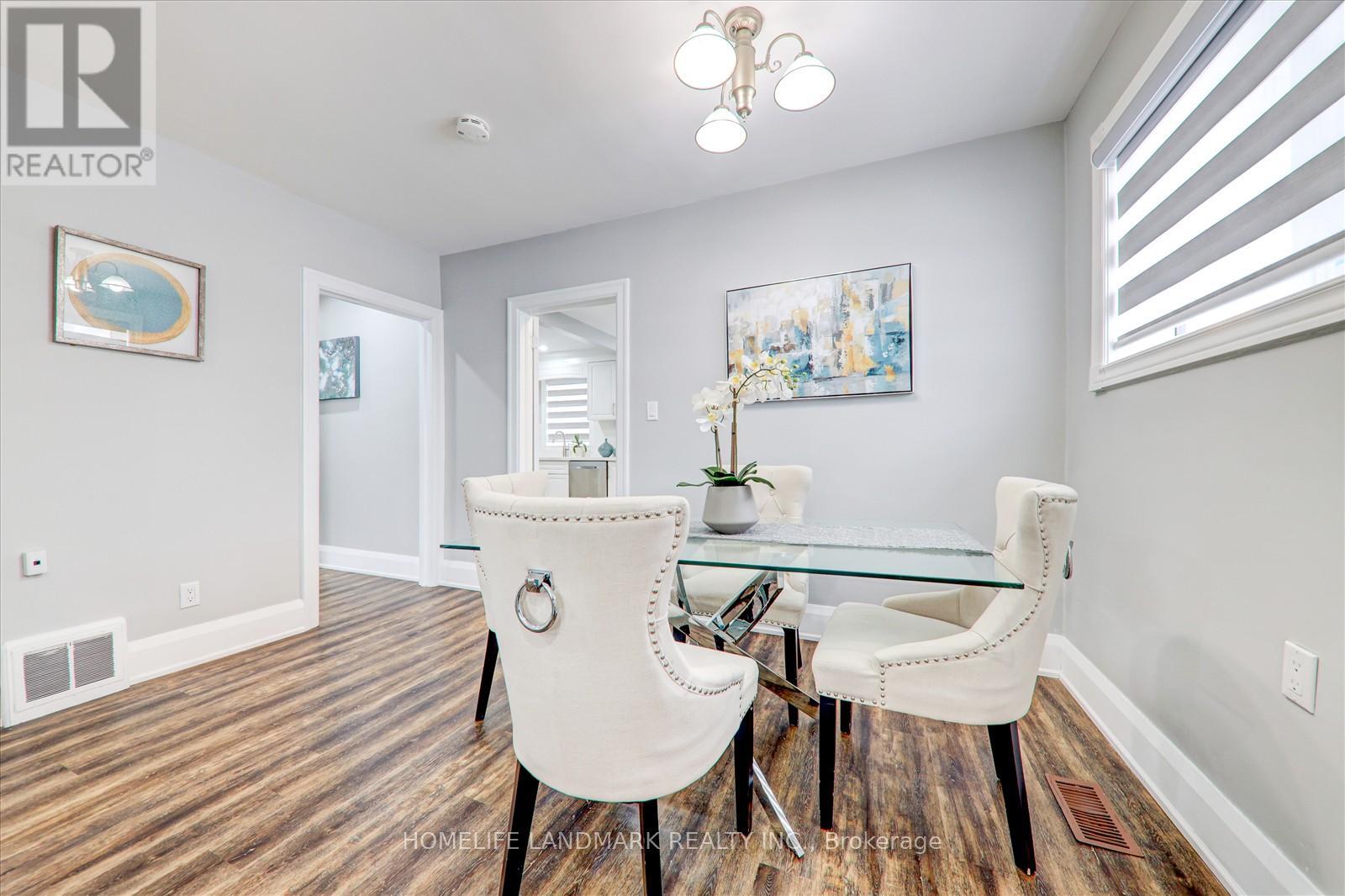 A dining room with a glass table and chairs.