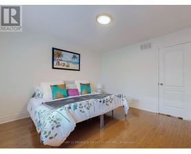 A bedroom with a bed and a picture on the wall.