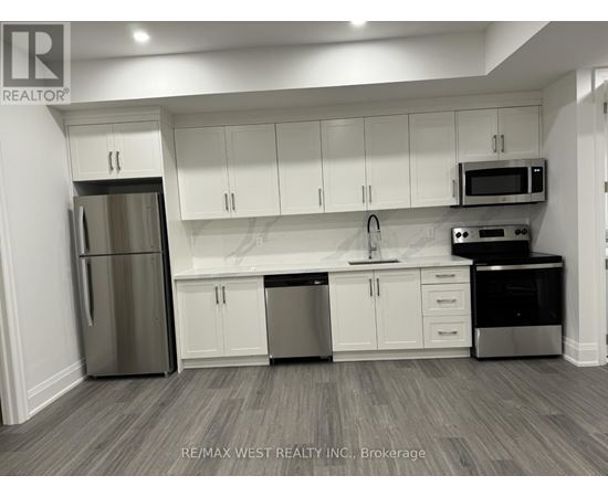 A kitchen with white cabinets and stainless steel appliances.