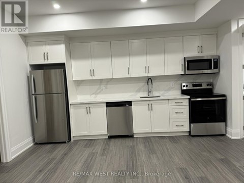 A kitchen with white cabinets and stainless steel appliances.