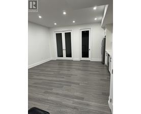 A room with grey flooring and white walls.
