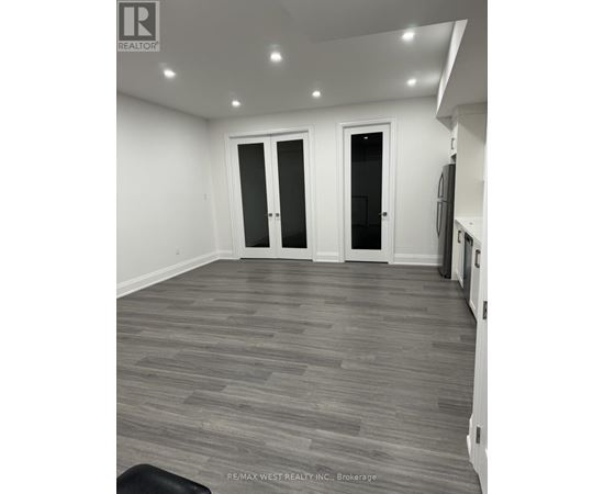 A room with grey flooring and white walls.