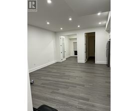 A room with grey flooring and white walls.