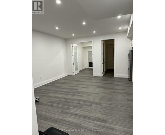 A room with grey flooring and white walls.