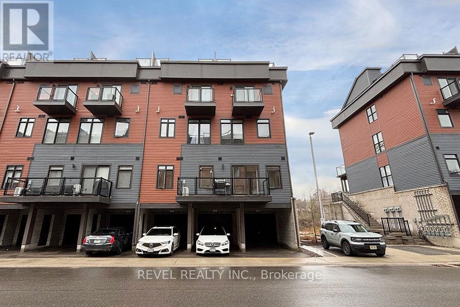 A building with the text REVEL REALTY INC. Brokerage on the side of it.