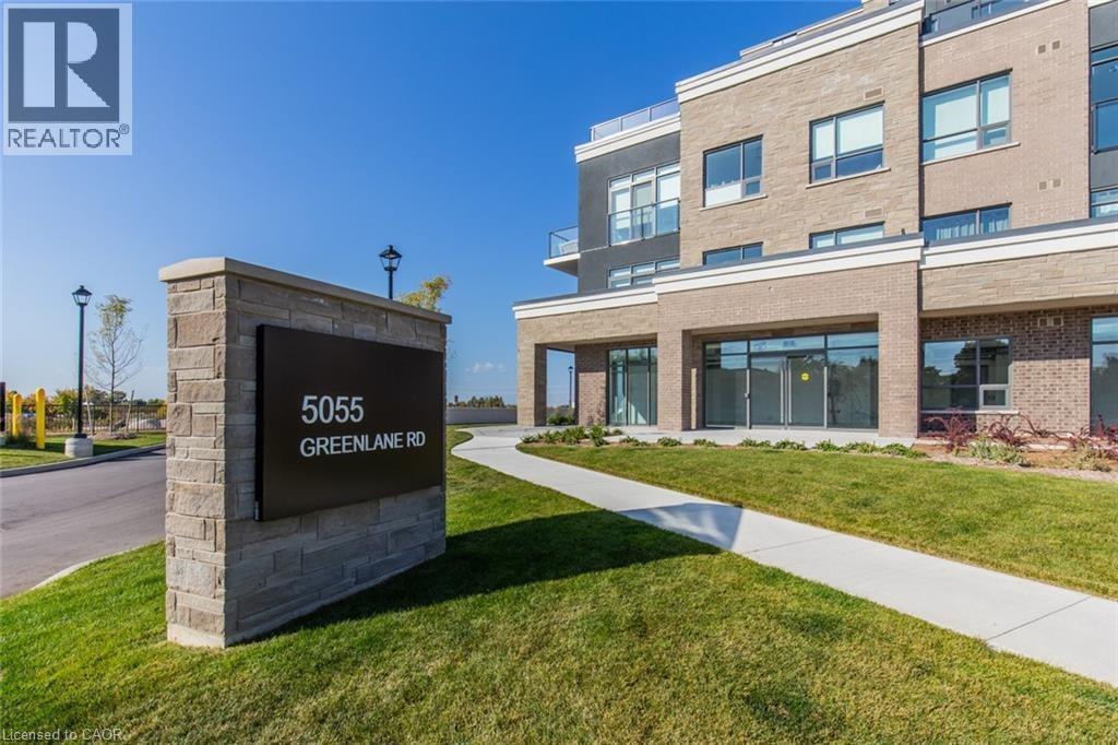 A sign for 5055 Greenlane Rd is in front of a building.