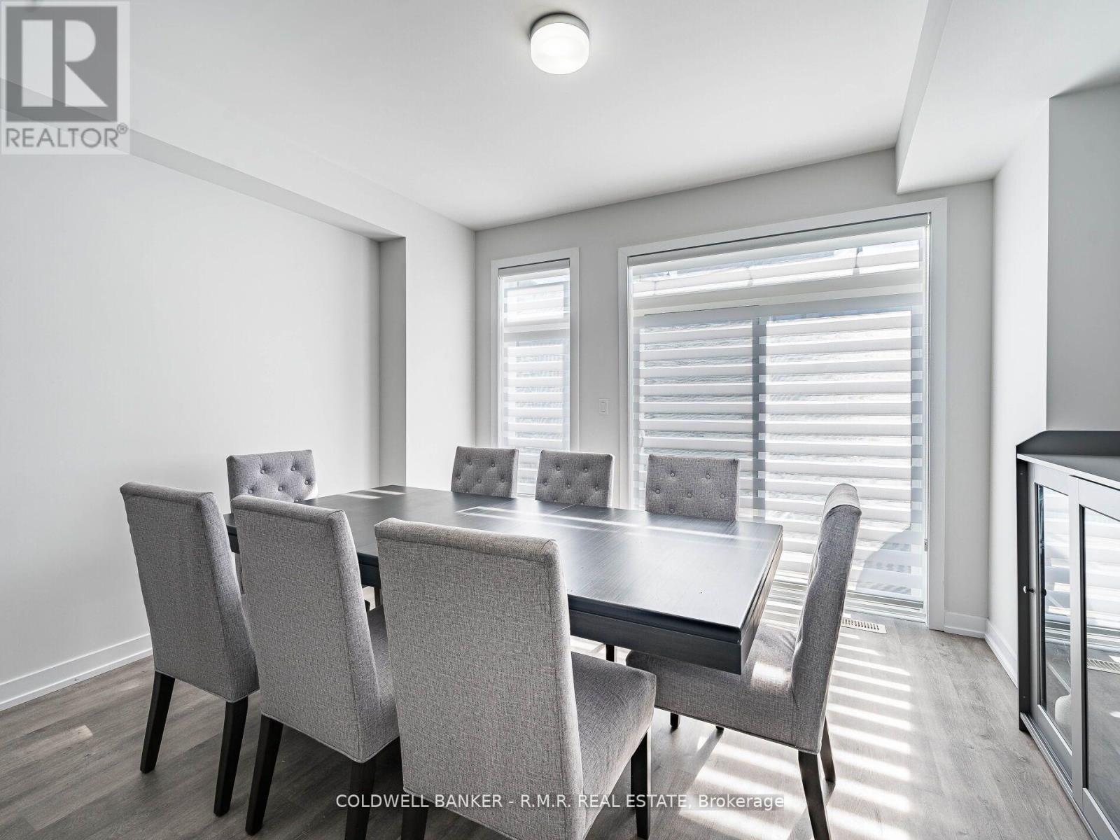 A dining room with a table and chairs.