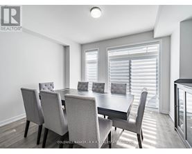 A dining room with a table and chairs.