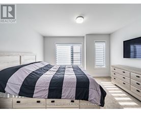 A bedroom with a bed, dresser, and window with blinds.