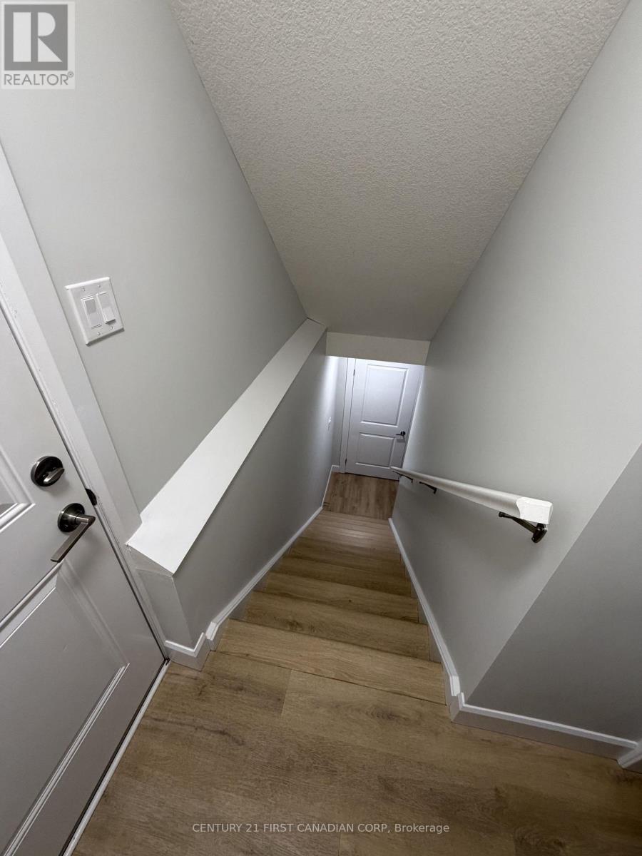 A hallway with a wooden floor and white walls.