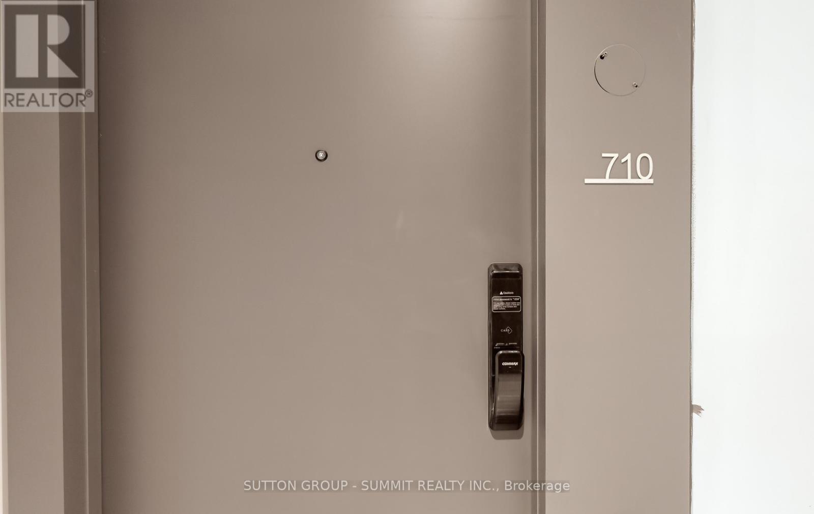 A door with a handle and a keypad lock.