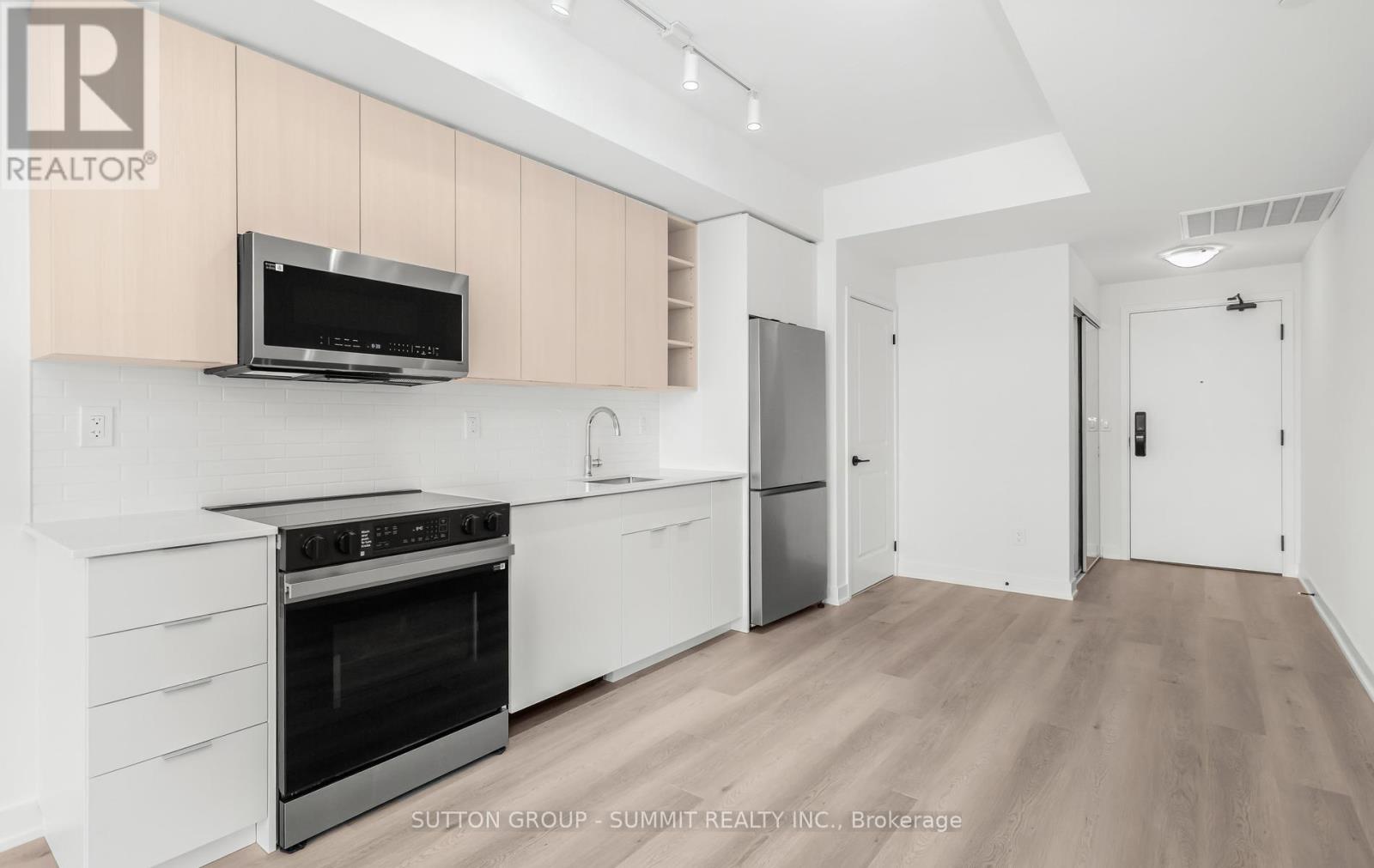 A modern kitchen with a stainless steel oven and microwave.