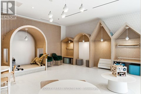 A modern living room with a white table and a giraffe plush toy.