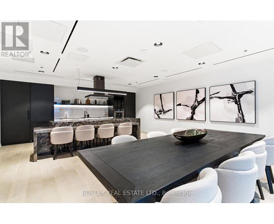 A modern dining room with a long table and chairs.
