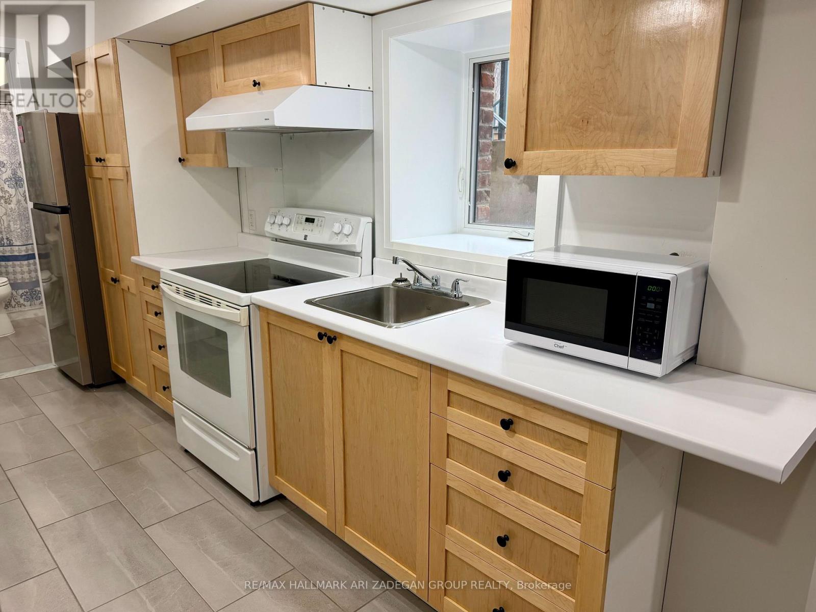 A kitchen with wooden cabinets and white appliances.