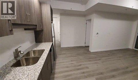 A kitchen with a sink and cabinets.