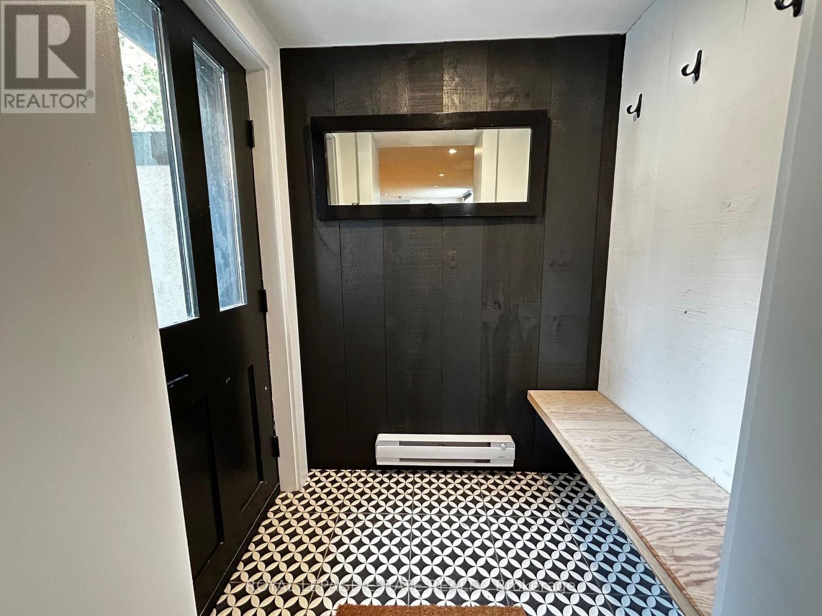 A bathroom with a black and white tiled floor.