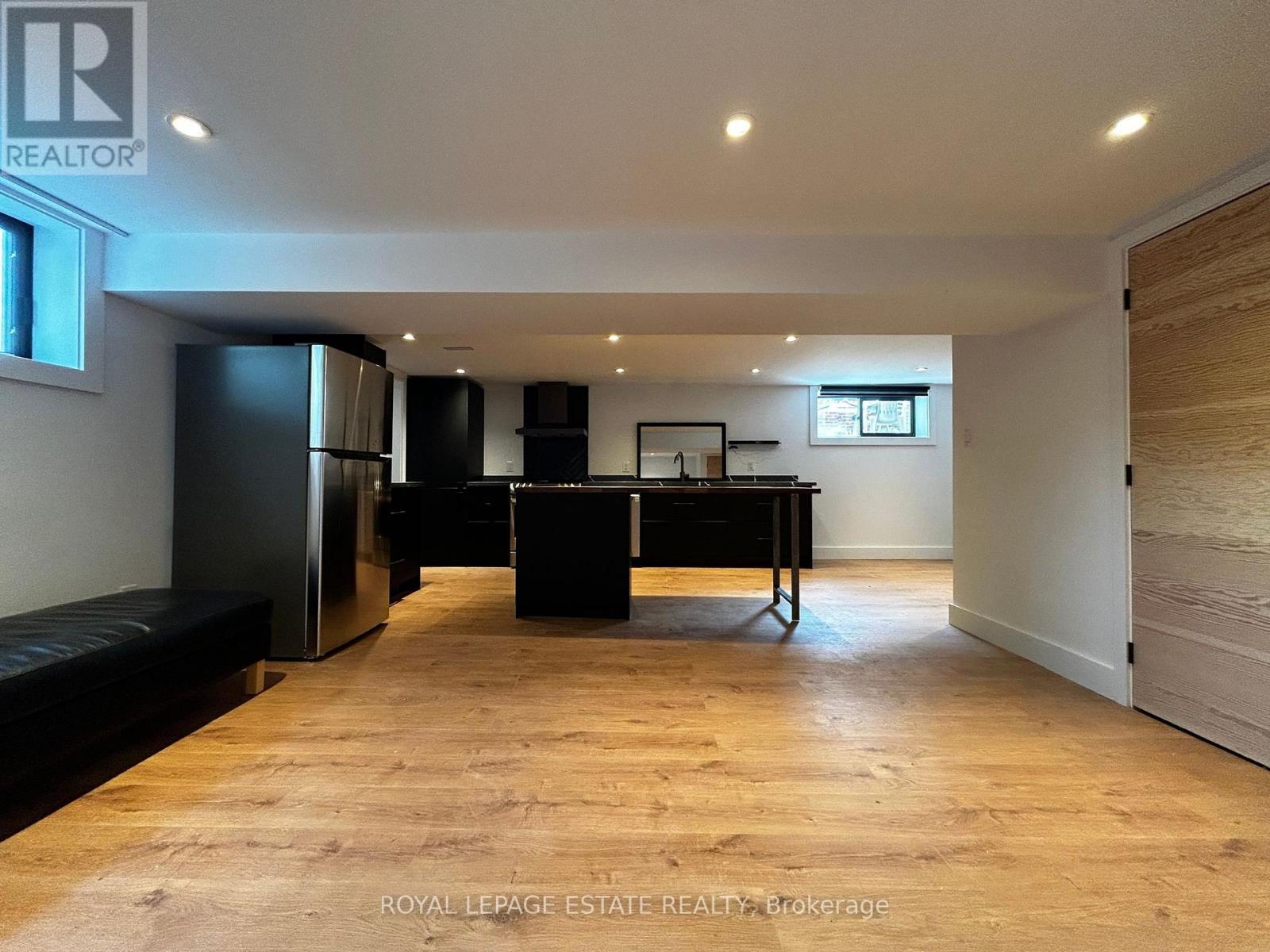 A spacious room with a black piano and a bench.