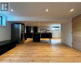 A spacious room with a black piano and a bench.