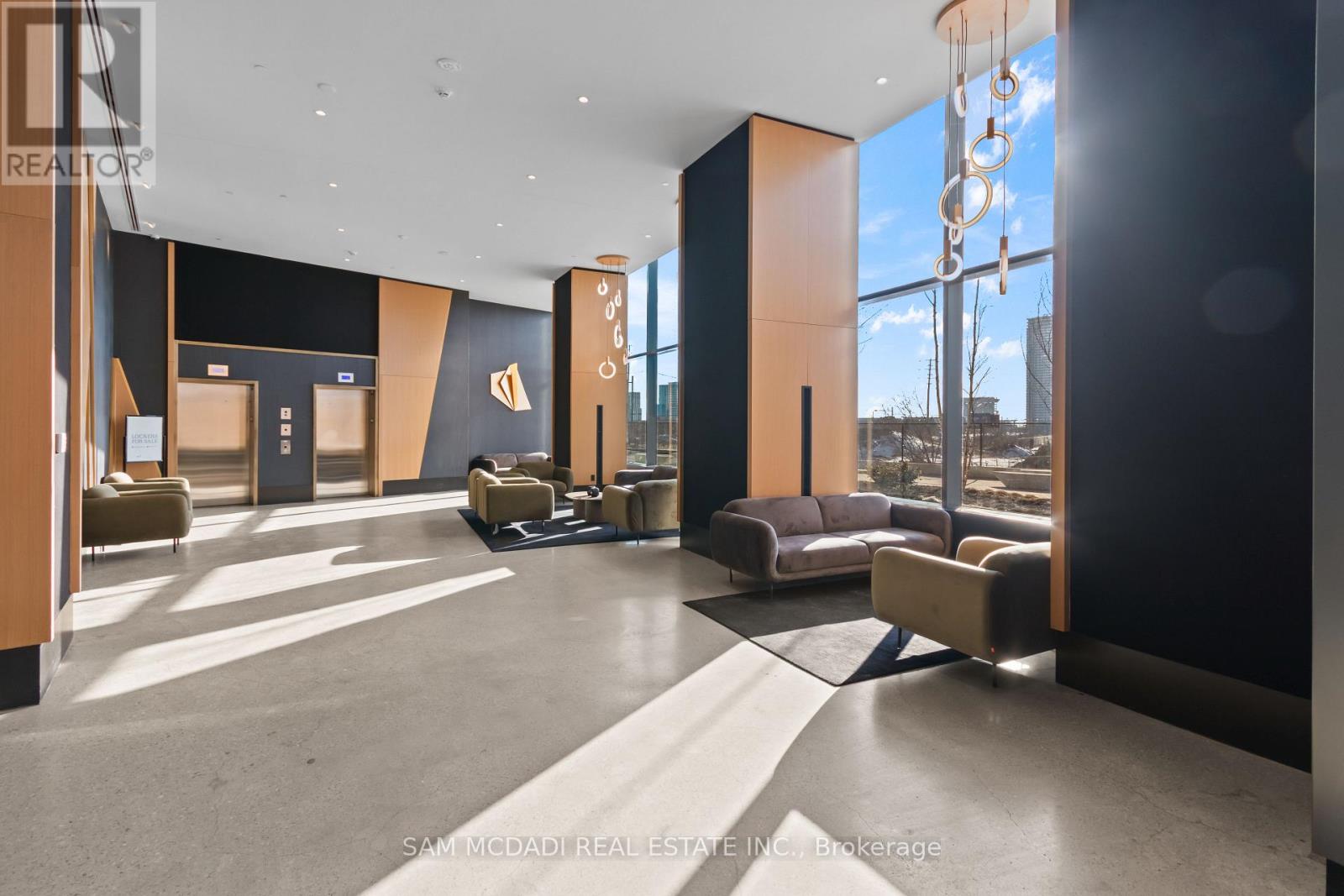 A modern interior space with a reception desk and seating area.