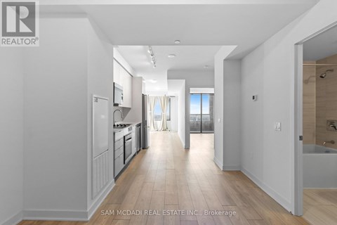 A spacious kitchen with white cabinets and a large island.